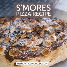 a pizza sitting on top of a pan covered in powdered sugar and toppings