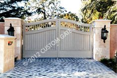 a driveway gate with two lights on each side