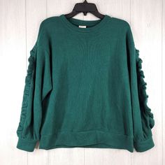 A New Day Green Pullover Crew Neck Womens Ruffle Sleeve Sweatshirt Green New With Tags Size: S, M Casual Fit Soft Ruffle Accents On Sleeves Ribbed Accents Long Sleeves Crew Neck Soft & Lightweight Fabric Below-Waist Lenght Knit Construction Ribbed Cuffs & Hem Banded Hem 60% Cotton 40% Polyester Machine Wash Cold Check Photo For Detailed List. **Please Check My Other Listings** E7-9237 Green Ruffle Sleeve Tops For Fall, Green Ruffled Winter Tops, Green Ruffled Tops For Winter, Winter Green Ruffled Tops, Casual Ruffled Crew Neck Sweatshirt, Burnt Orange Sweater, Yellow Crewneck, Baby Blue Sweater, Tie Front Sweater