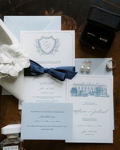 the wedding stationery is laid out on top of the table with its matching accessories