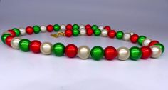 Christmas Miracle Bead Necklace in gorgeous red, green and ivory gold 8mm beads with optional matching bracelet and earrings.  A great stocking filler, secret Santa or Christmas party necklace! Miracle beads are acrylic beads which are mirrored and then coated in colourful varnish.  As a result, when the catch the light, they 'glow' much in the same way as cats eyes.  They are equally effective in natural or artificial light.  Necklaces made from these beads never fail to draw admiration and com Christmas Jewelry Gift, Christmas Miracle, Cats Eyes, Suntan Lotion, Christmas Necklace, 8mm Beads, Artificial Light, Party Necklace, Necklace Red