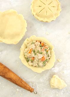 three pie crusts, one with chicken and the other with vegetable filling in them