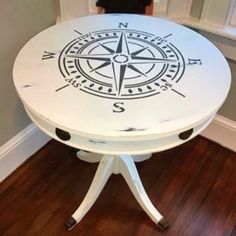 a white table with a compass design on it