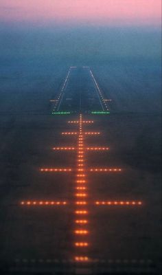 an airport runway with lights on it