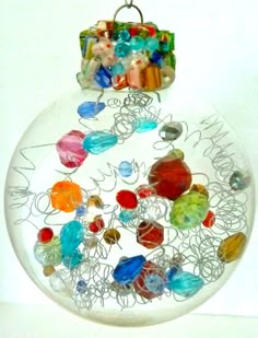 a glass ornament filled with lots of different colored beads