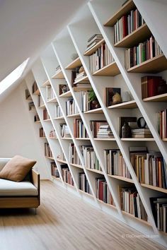 a couch sitting in front of a book shelf filled with books on top of wooden floors