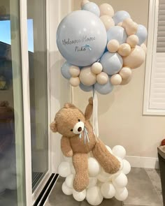 a teddy bear holding onto some balloons