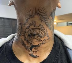 a man's neck with an all seeing eye tattoo on the upper part of his neck