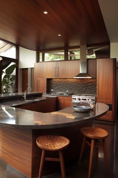 a kitchen with an island and two stools in it's center counter area