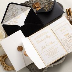 the wedding stationery is laid out on top of an ornate silver platter with gold accents