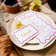 the table is set with two menus and place settings