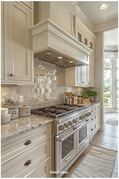 a kitchen with white cabinets and marble counter tops is pictured in this image from the front view