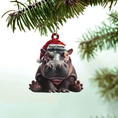 a hippopotamus ornament hanging from a christmas tree