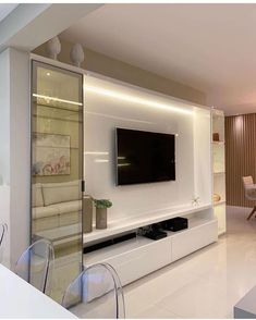 a large flat screen tv mounted to the side of a wall in a living room