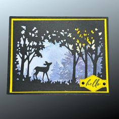 a handmade card with an image of a deer in the woods