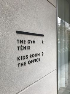 the gym sign is on the side of a building that says kids room / the office