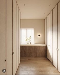 an empty room with white walls and wooden flooring is seen from the hallway to the bedroom