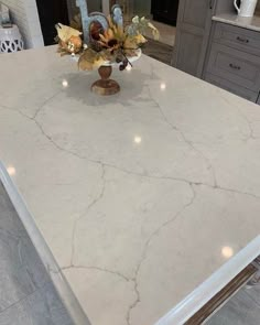 a white counter top with some flowers in it