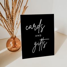 there is a card with the words cards and gifts on it next to a vase