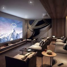 a large room with couches, chairs and a projector screen in the corner