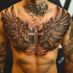 a man with tattoos on his chest has a cross and wings tattoo on his chest