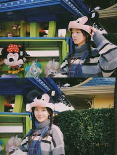 two women standing next to each other in front of a building with mickey mouse decorations on it