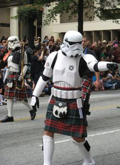 two men dressed as stormtroopers in tartan kilts and white helmets