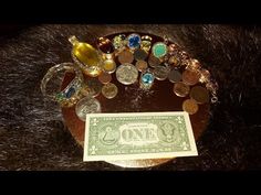 a pile of coins sitting on top of a table next to a paper money bill