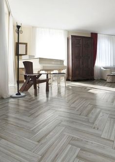 a living room filled with furniture and a piano in the middle of it's floor