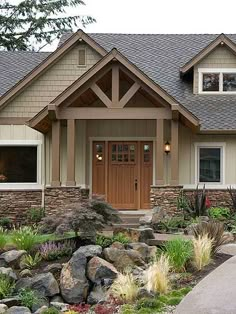 a house that has rocks and plants in front of it