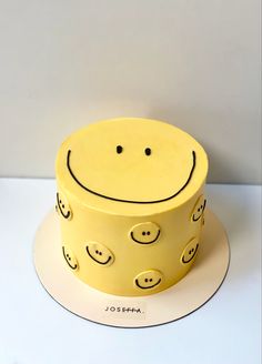 a yellow cake with smiley faces on it