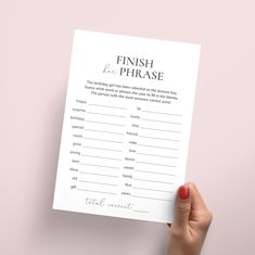 a hand holding up a printable finish the phrase game on top of a pink background