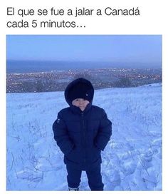 a little boy standing in the snow wearing a jacket