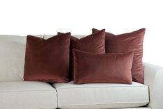 three brown pillows on a white couch