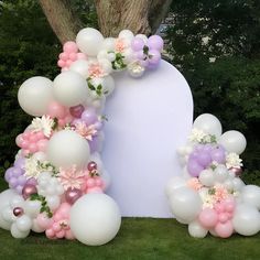 balloons and flowers are arranged in the shape of an arch