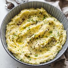 a bowl filled with mashed potatoes on top of a table