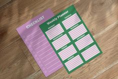 two checklist stickers sitting on top of a wooden floor