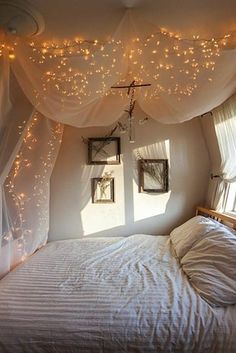 an image of a bedroom with lights on the ceiling and curtains over the bed,