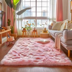 a living room filled with furniture and a pink rug