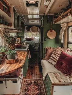 the interior of an rv with green walls and wood flooring is decorated in rustic style