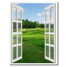 an open door leading to a green golf course with trees and blue sky in the background