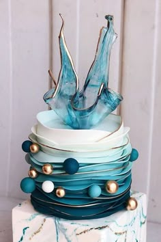 a stack of blue and white plates stacked on top of each other with gold accents