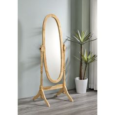 a wooden stand with a mirror and potted plant next to it on the floor