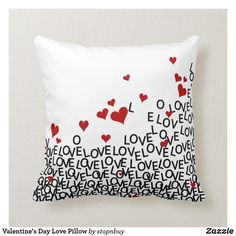 a white pillow with red and black hearts on the front, along with i love you written across it