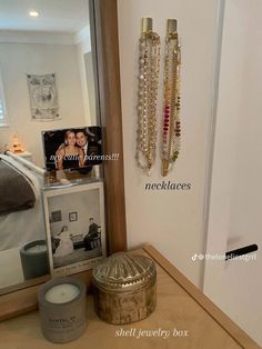 there is a mirror and some jewelry on the shelf in front of the door to the bedroom