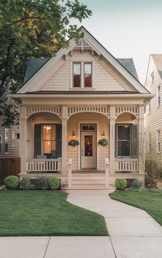 a white house with two front porches and green grass