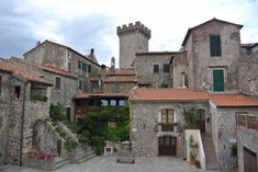 an old stone building with red tiled roofs