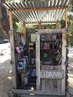 an old wooden library with books on it and a sign that says library in the window