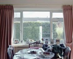 the dining room table is set with plates and silverware, along with two chairs