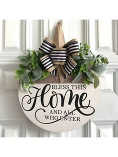 a door hanger with a bow on it that says, bless this home and all who enter